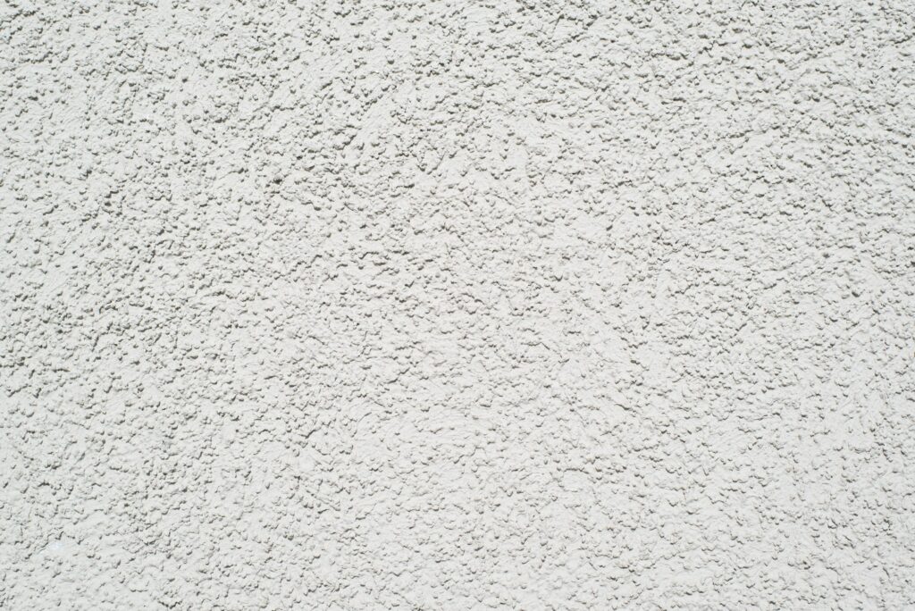 White rubber flooring, textured grainy surface background, outdoor sports ground floor. Top view